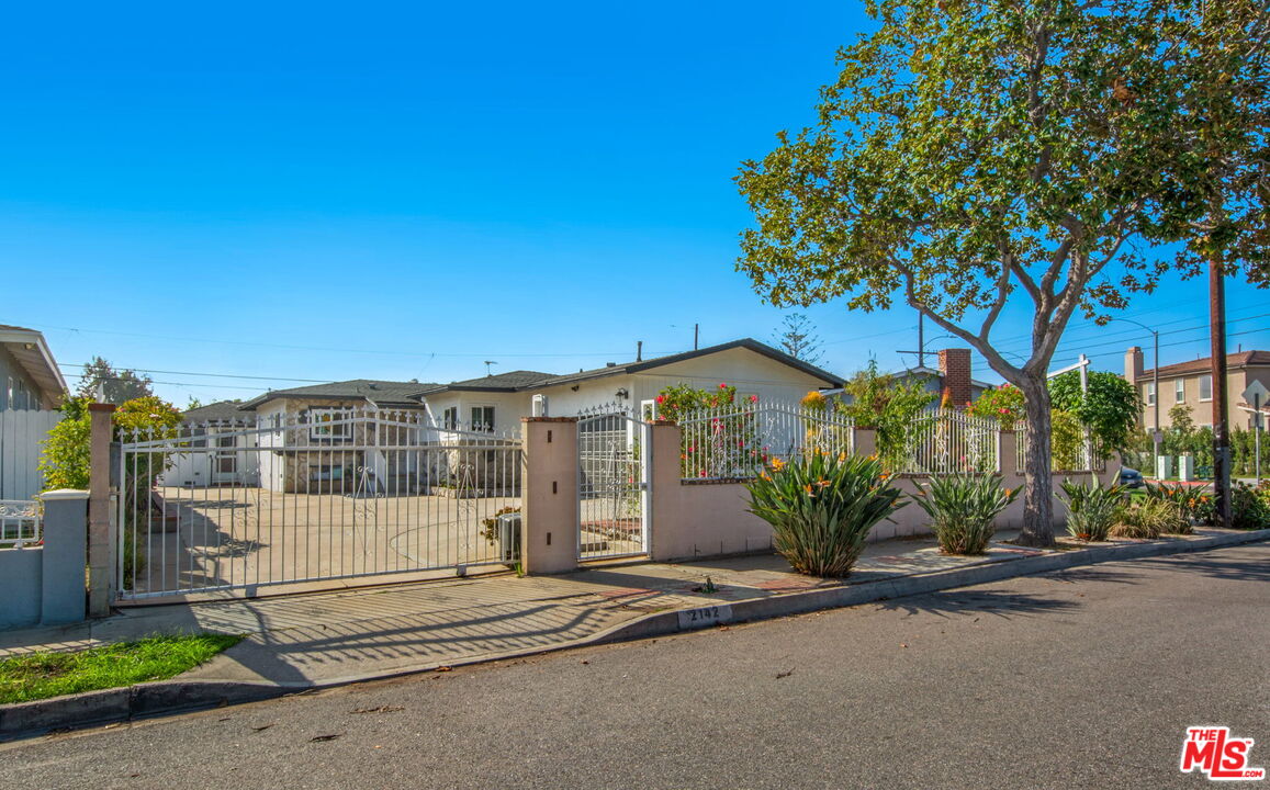 2142 West 11th Street Santa Ana, CA 92703 - Photo 54 of 54 a front view of a house with a yard and a garage