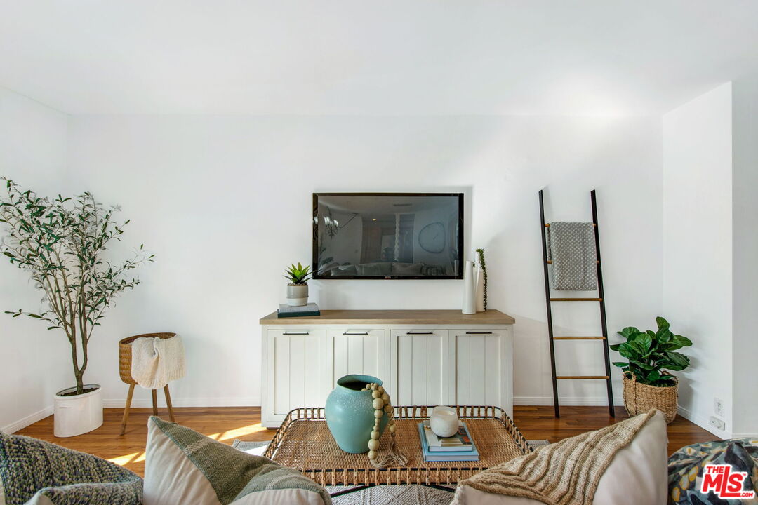 2142 West 11th Street Santa Ana, CA 92703 - Photo 7 of 54 a living room with furniture a chandelier and a flat screen tv