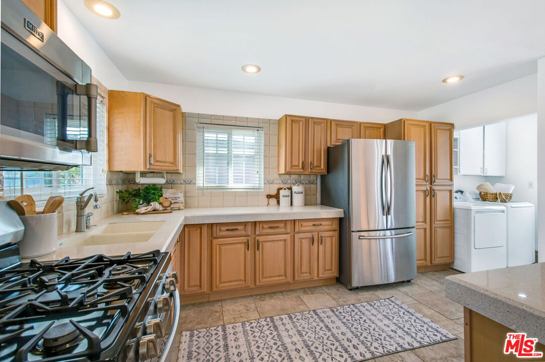 2142 West 11th Street Santa Ana, CA 92703 - Photo 9 of 54 a kitchen with a refrigerator and a sink