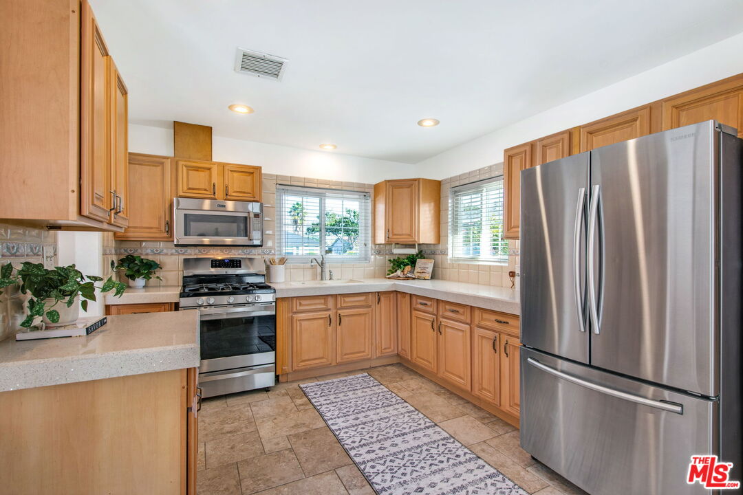 2142 West 11th Street Santa Ana, CA 92703 - Photo 10 of 54 a kitchen with stainless steel appliances granite countertop a refrigerator sink and stove