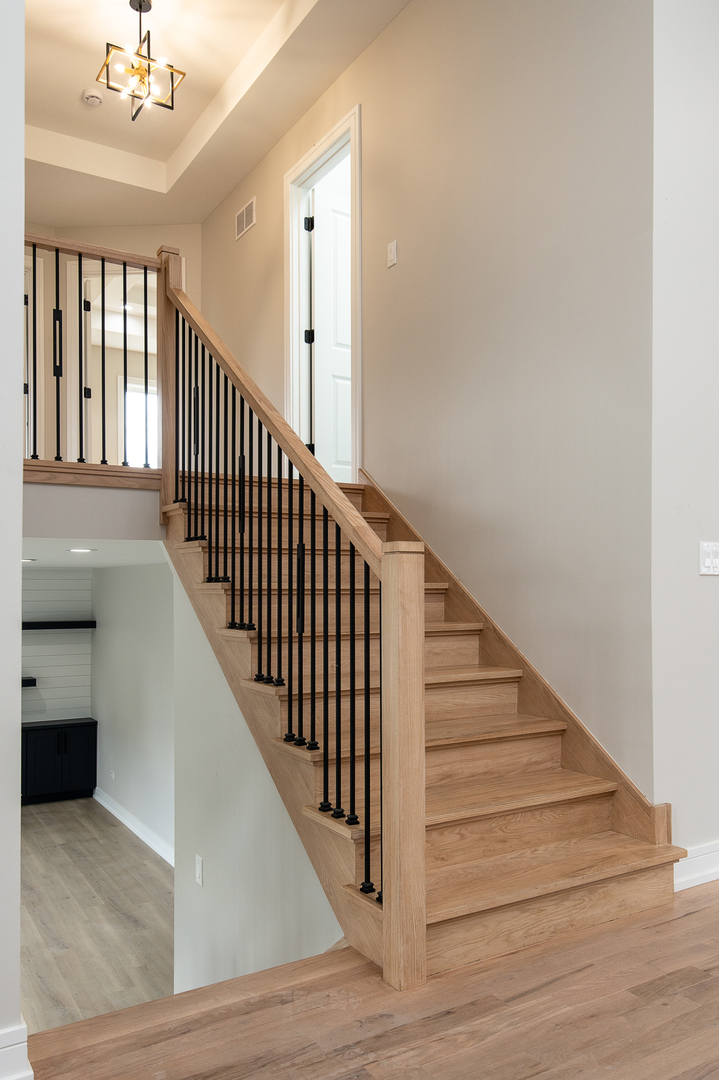 7951 West 73rd Place Bridgeview, IL 60455 - Photo 18 of 41 a view of staircase with railing and pendant lights