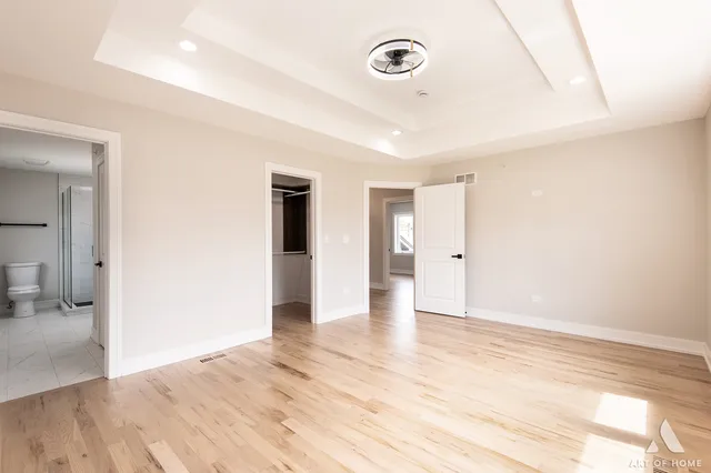 a view of an empty room and wooden floor