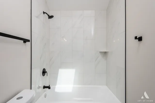 a bathroom with a bathtub and a shower