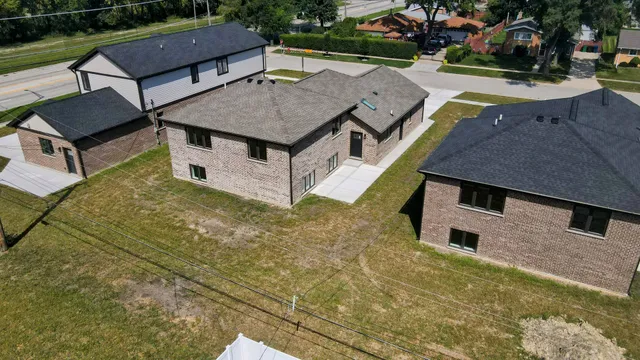 a view of a house with a yard and sitting area