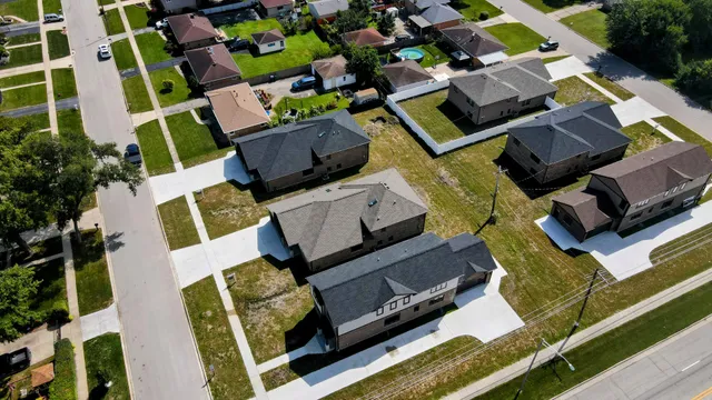 an aerial view of residential house with outdoor space and seating area