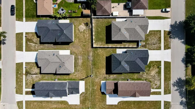 an aerial view of houses with outdoor space