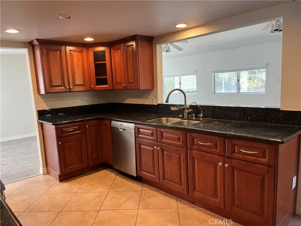 a kitchen with granite countertop a sink and cabinets