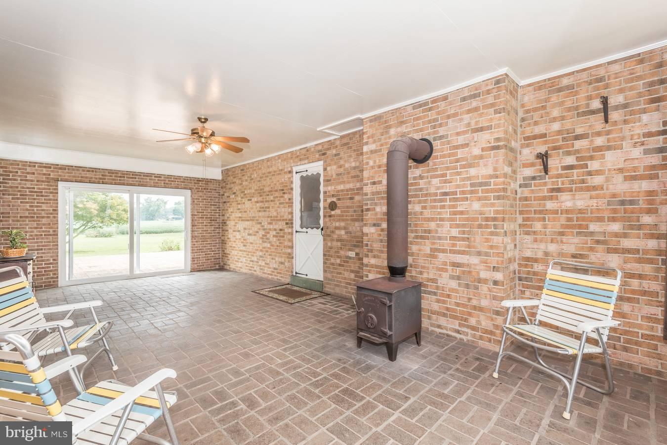 5910 Adamstown Road Adamstown, MD 21710 - Photo 13 of 28 Breezeway with wood burning stove