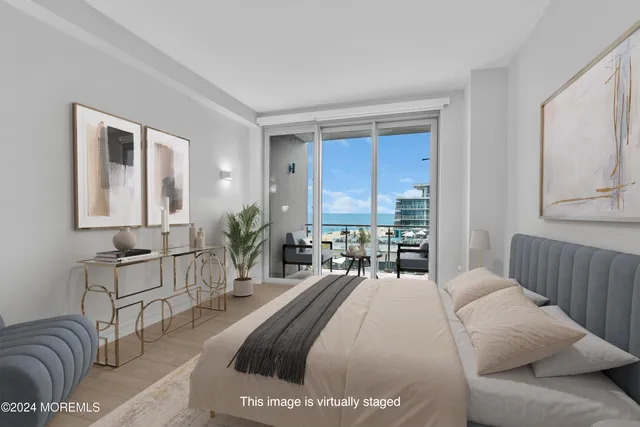 a spacious bedroom with a bed a mirror and lamp