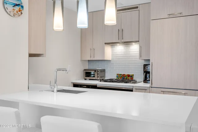 a kitchen with stainless steel appliances a sink a stove and a refrigerator