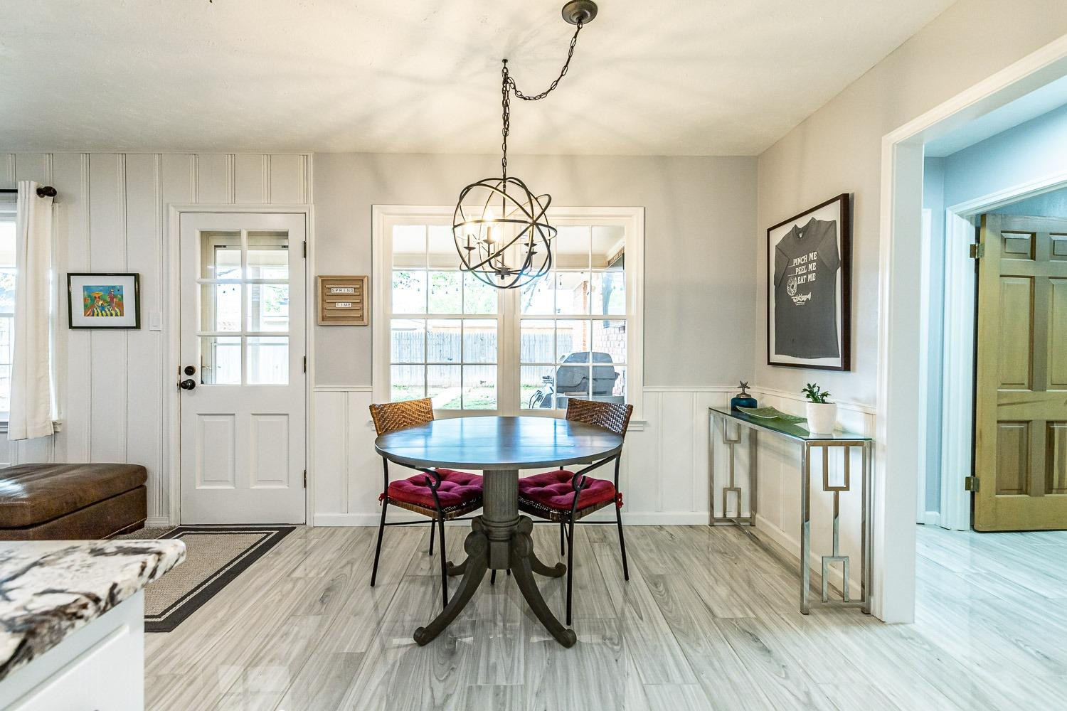 3417 61st Street Lubbock, TX 79413 - Photo 12 of 39 a view of a dining room with furniture window and wooden floor