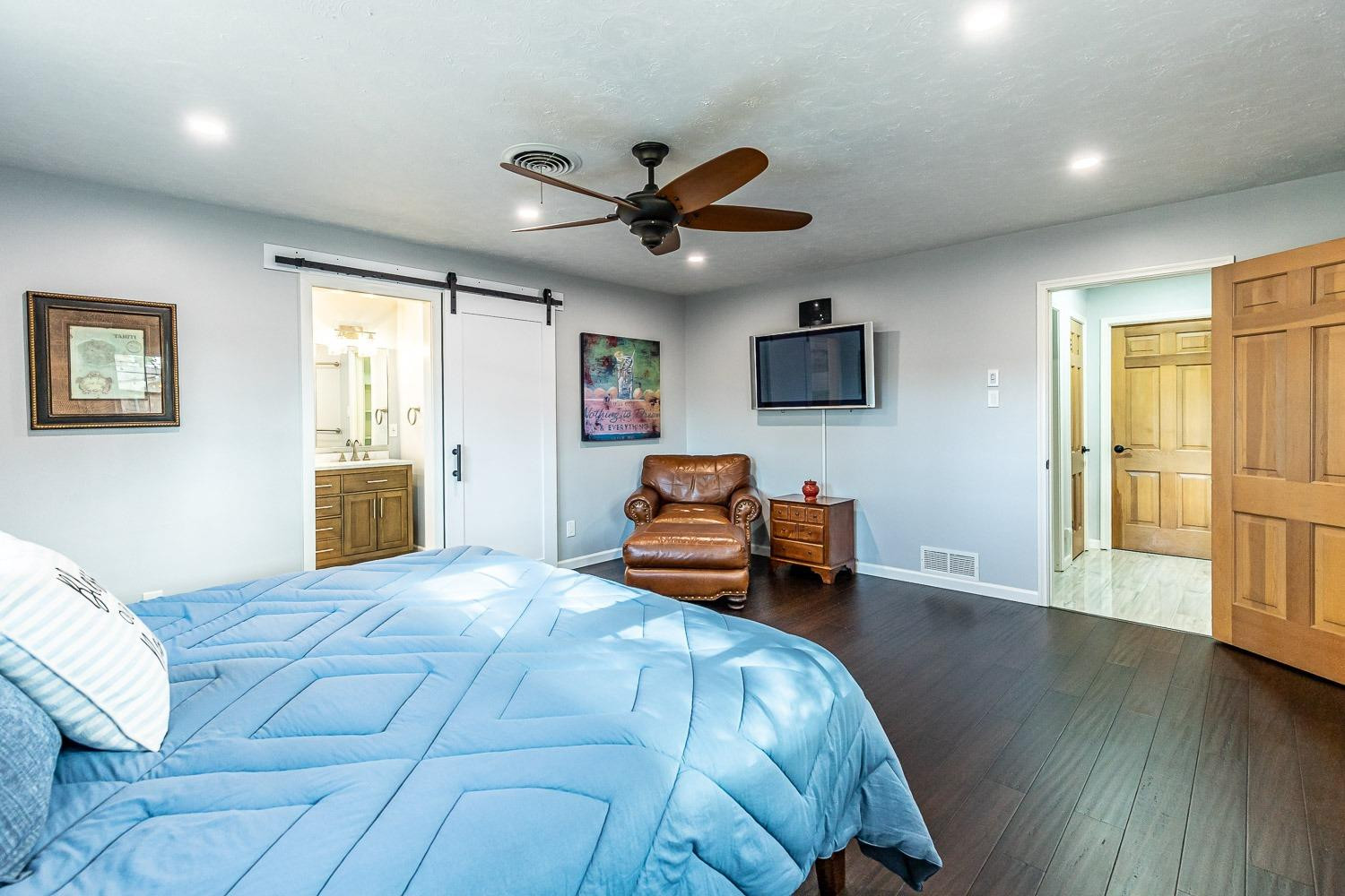 3417 61st Street Lubbock, TX 79413 - Photo 19 of 39 a bedroom with a bed and wooden floor