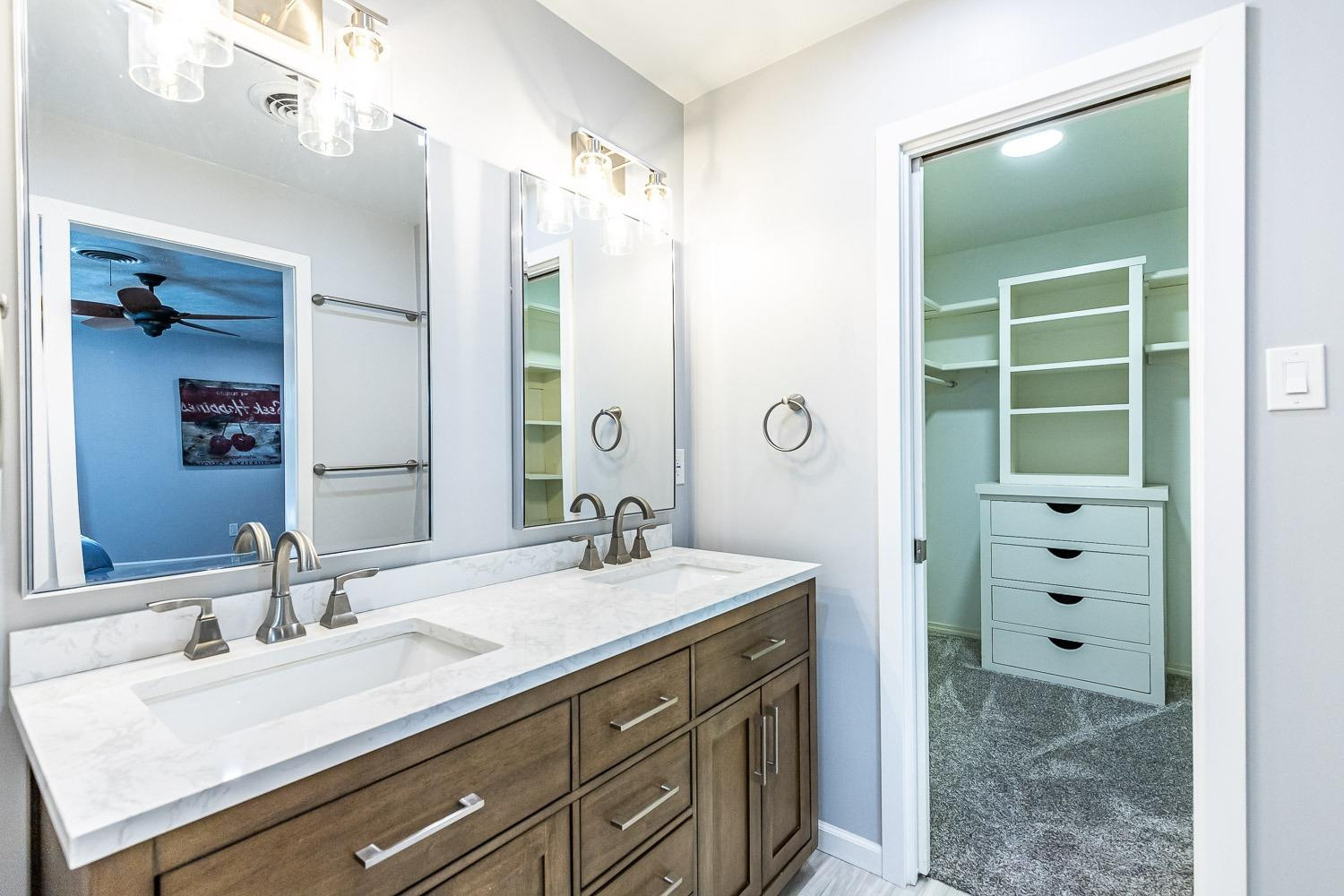 3417 61st Street Lubbock, TX 79413 - Photo 24 of 39 a bathroom with a sink double vanity and a mirror