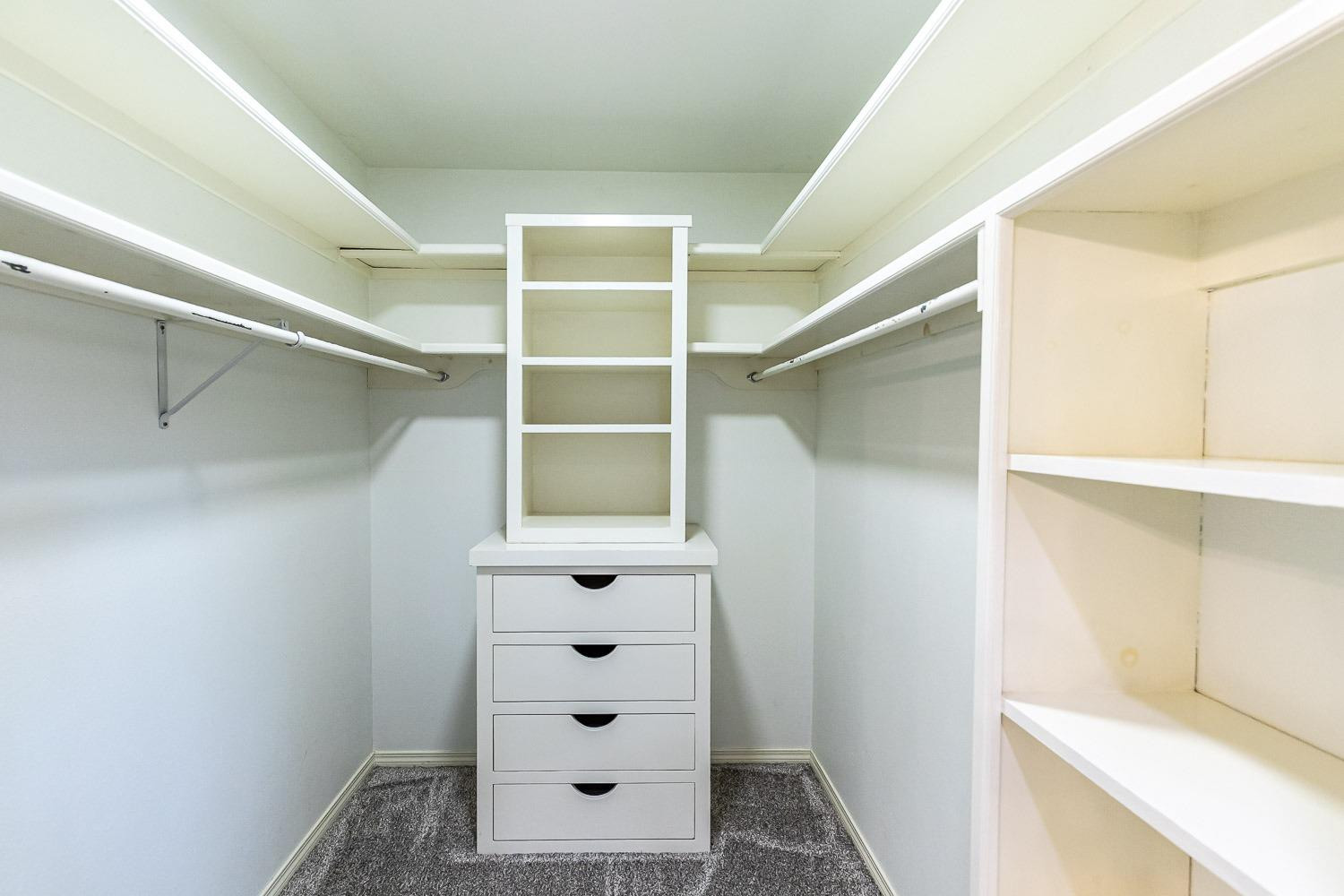 3417 61st Street Lubbock, TX 79413 - Photo 25 of 39 a view of walk in closet with empty racks