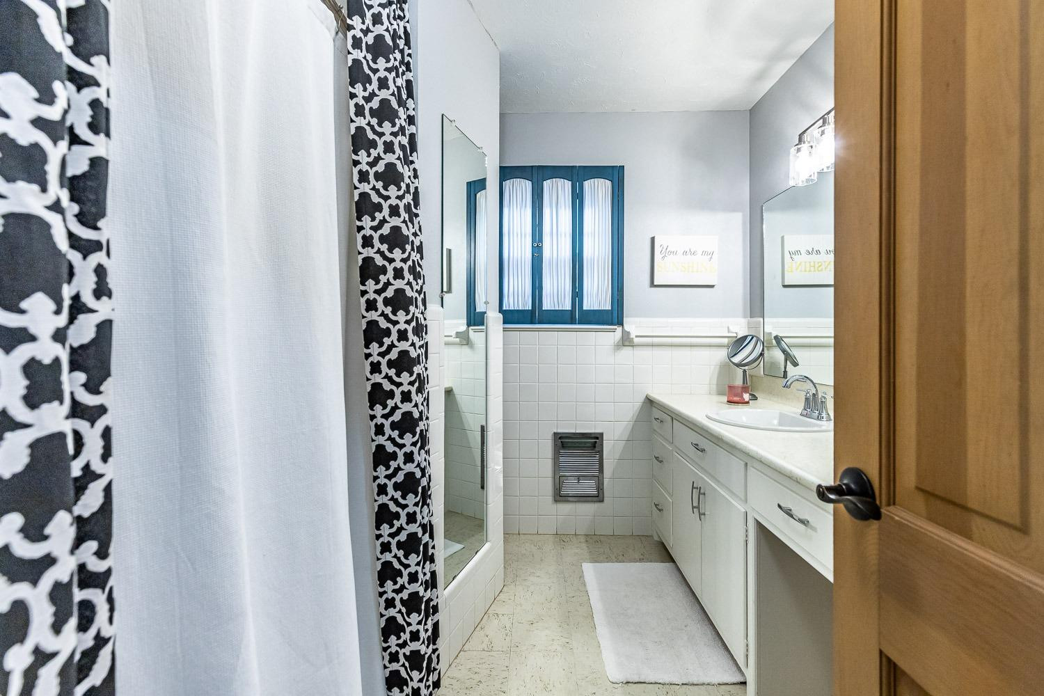 3417 61st Street Lubbock, TX 79413 - Photo 28 of 39 a spacious bathroom with a double vanity sink mirror and