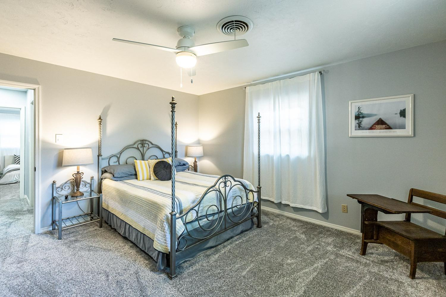 3417 61st Street Lubbock, TX 79413 - Photo 30 of 39 a bedroom with a bed and a chair