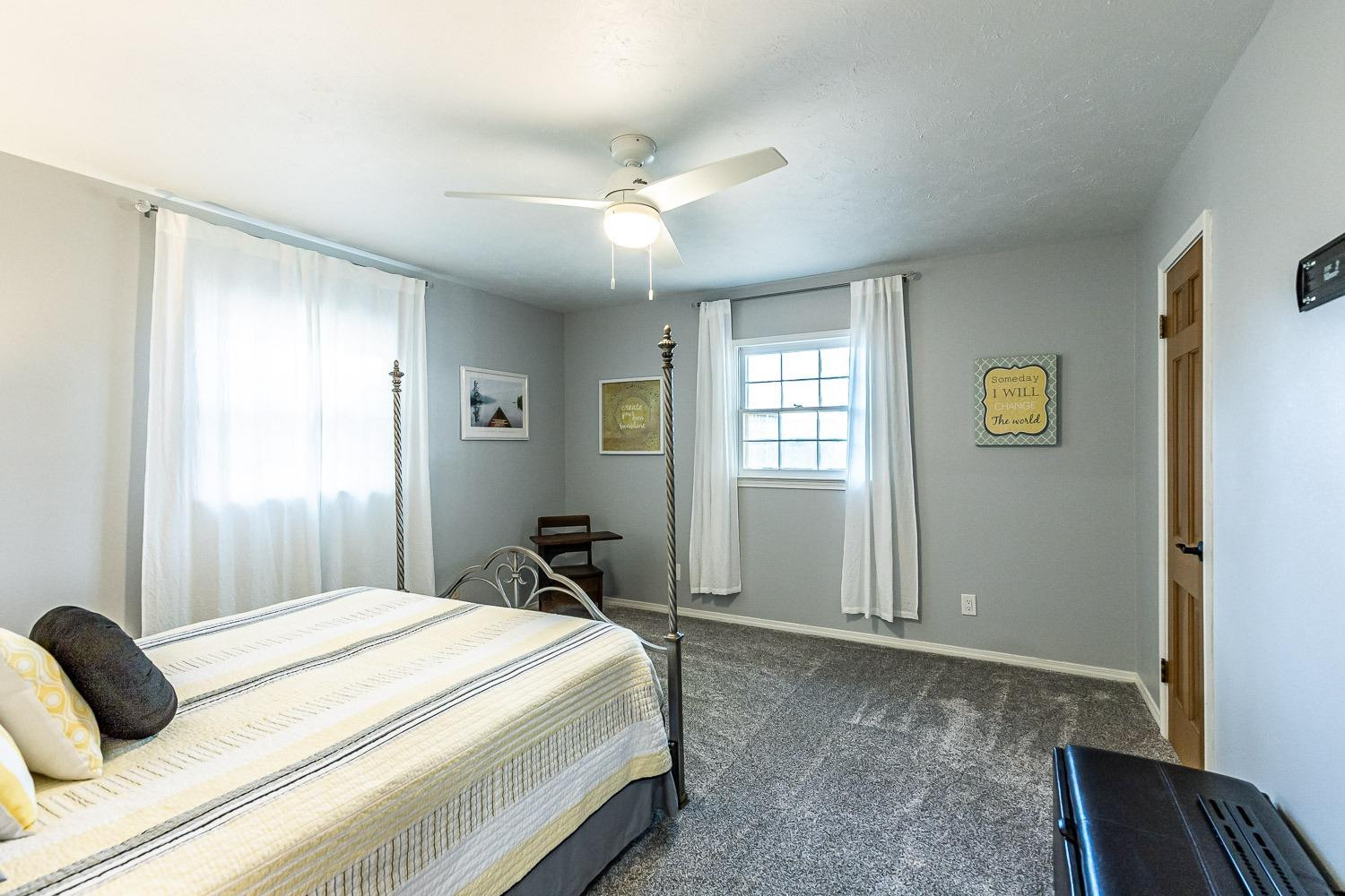 3417 61st Street Lubbock, TX 79413 - Photo 31 of 39 a bedroom with a bed and wooden floor