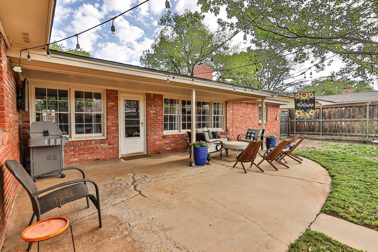 3417 61st Street Lubbock, TX 79413 - Photo 33 of 39 a view of a house with backyard sitting area and garden