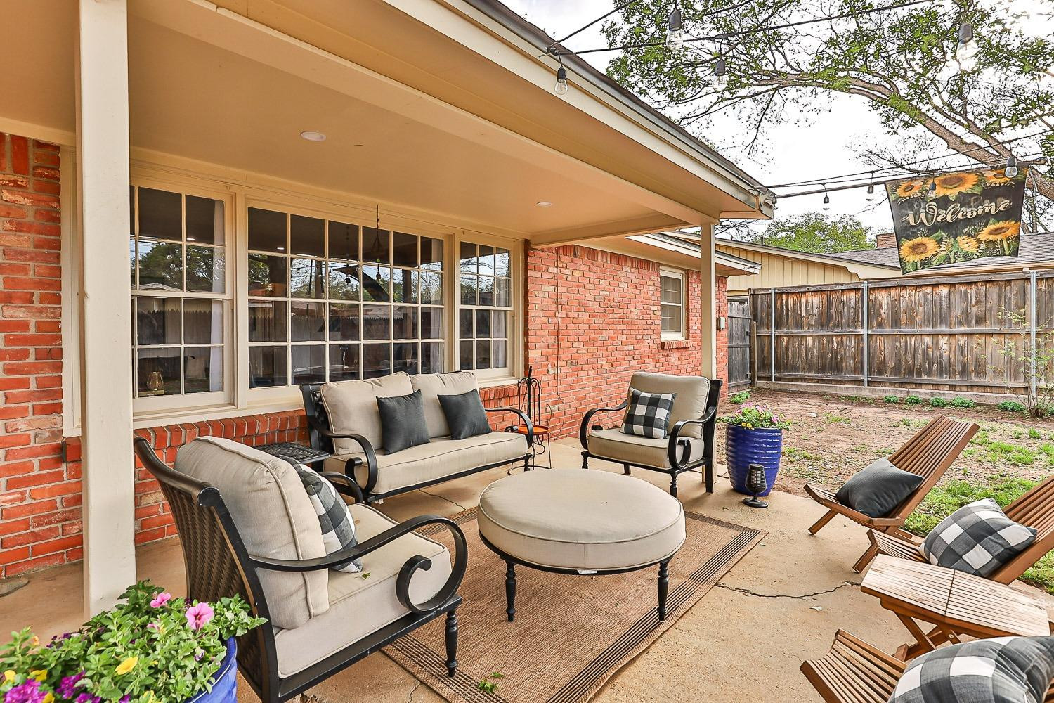 3417 61st Street Lubbock, TX 79413 - Photo 34 of 39 a view of a patio with couches table and chairs and potted plants
