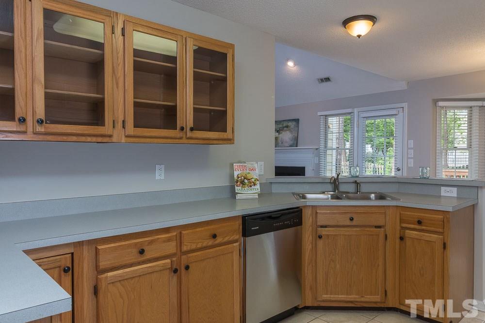 12404 Harcourt Drive Raleigh, NC 27613 - Photo 9 of 22 a kitchen with granite countertop cabinets sink and window