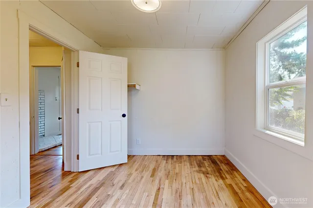 a view of a room with wooden floor and window