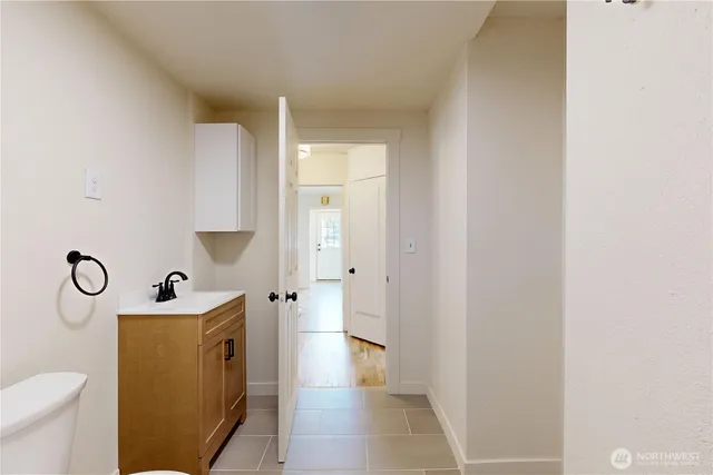 a bathroom with a sink mirror vanity and toilet