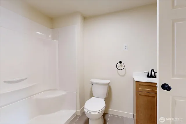 a white toilet sitting next to a bath tub