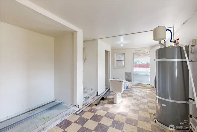 a view of a refrigerator in kitchen and empty room