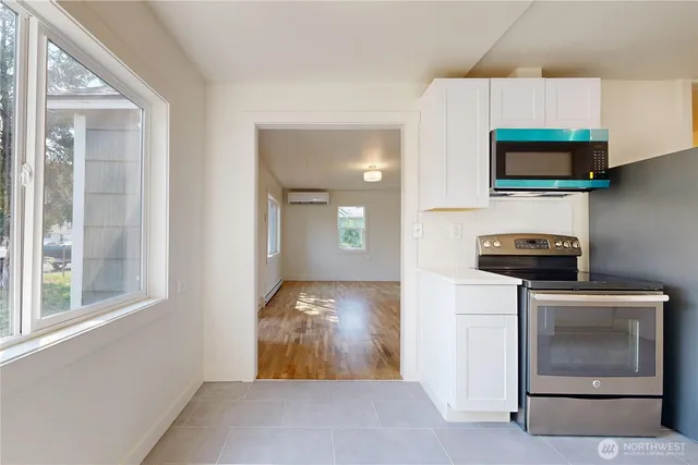 a kitchen with stainless steel appliances a stove microwave and refrigerator