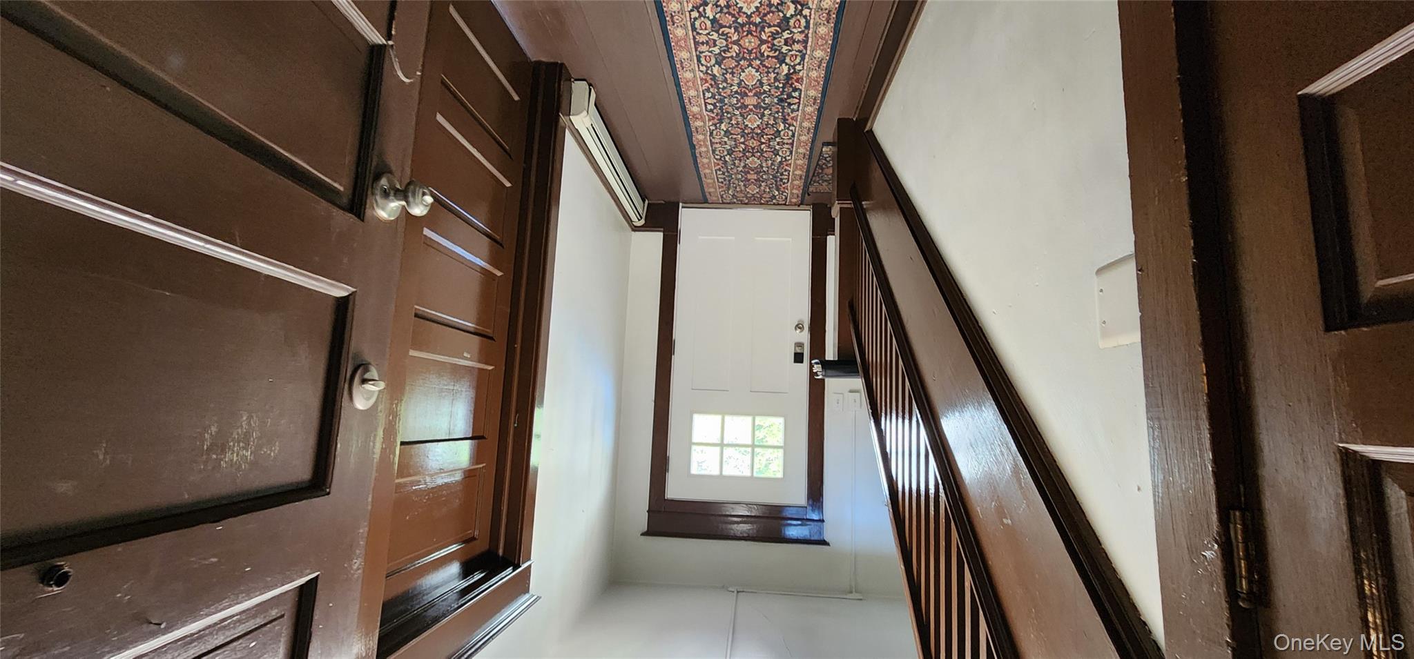 20 Delaware Street, Unit 2 Port Jervis, NY 12771 - Photo 2 of 10 a view of a hallway with wooden floor and stairs