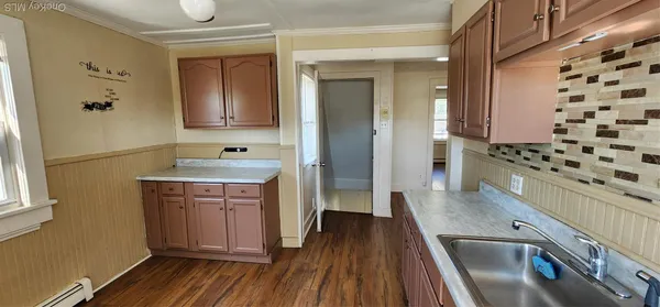 a kitchen with stainless steel appliances a stove a sink and a refrigerator