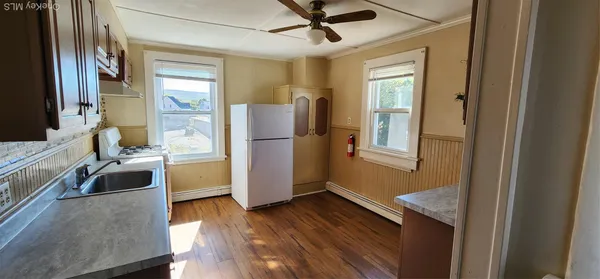 a kitchen with a refrigerator and a sink
