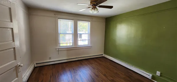 a view of room with window and hardwood floor