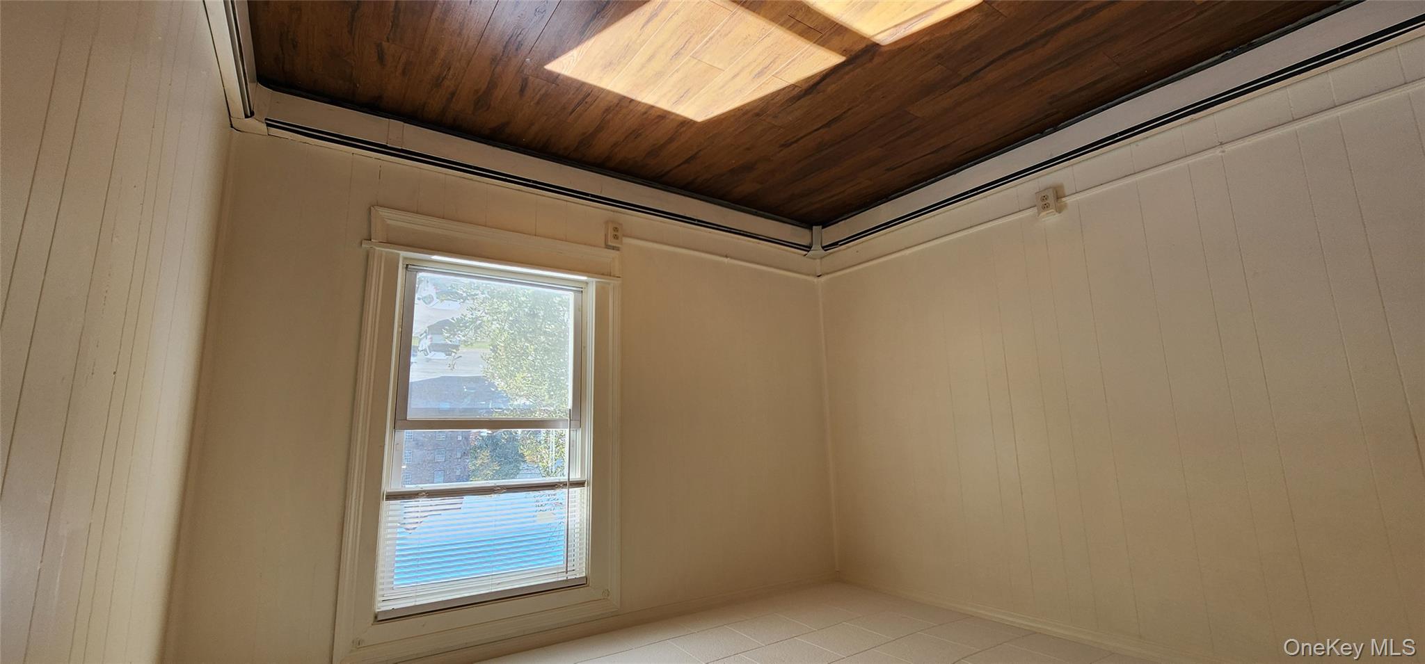 20 Delaware Street, Unit 2 Port Jervis, NY 12771 - Photo 7 of 10 an empty room with wooden floor and windows
