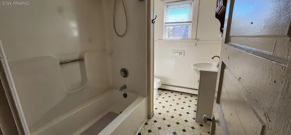 a bathroom with a bathtub and a shower