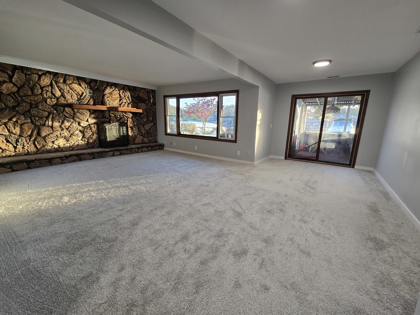 1007 North River Road McHenry, IL 60051 - Photo 2 of 26 a view of an empty room with window and fireplace