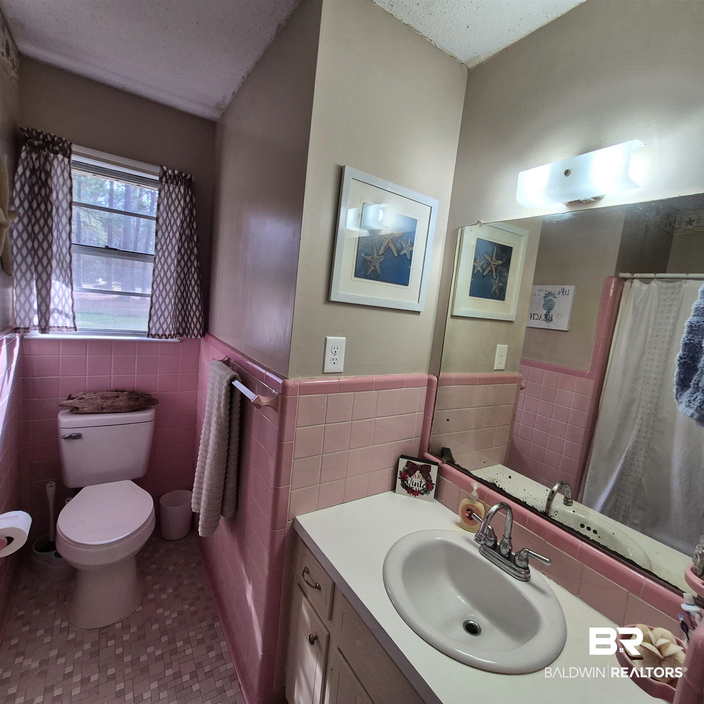 491 Forrest Avenue Castleberry, AL 36432 - Photo 20 of 33 Full bath with vanity, curtained shower, wainscoting, and tile walls