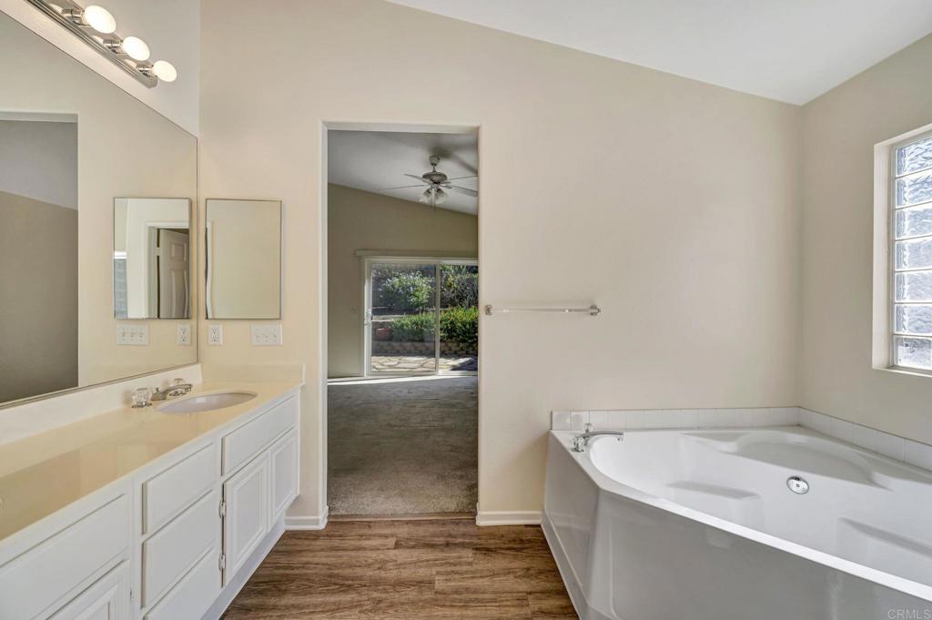 2775 Lobelia Road Alpine, CA 91901 - Photo 18 of 25 a spacious bathroom with a tub sink and mirror