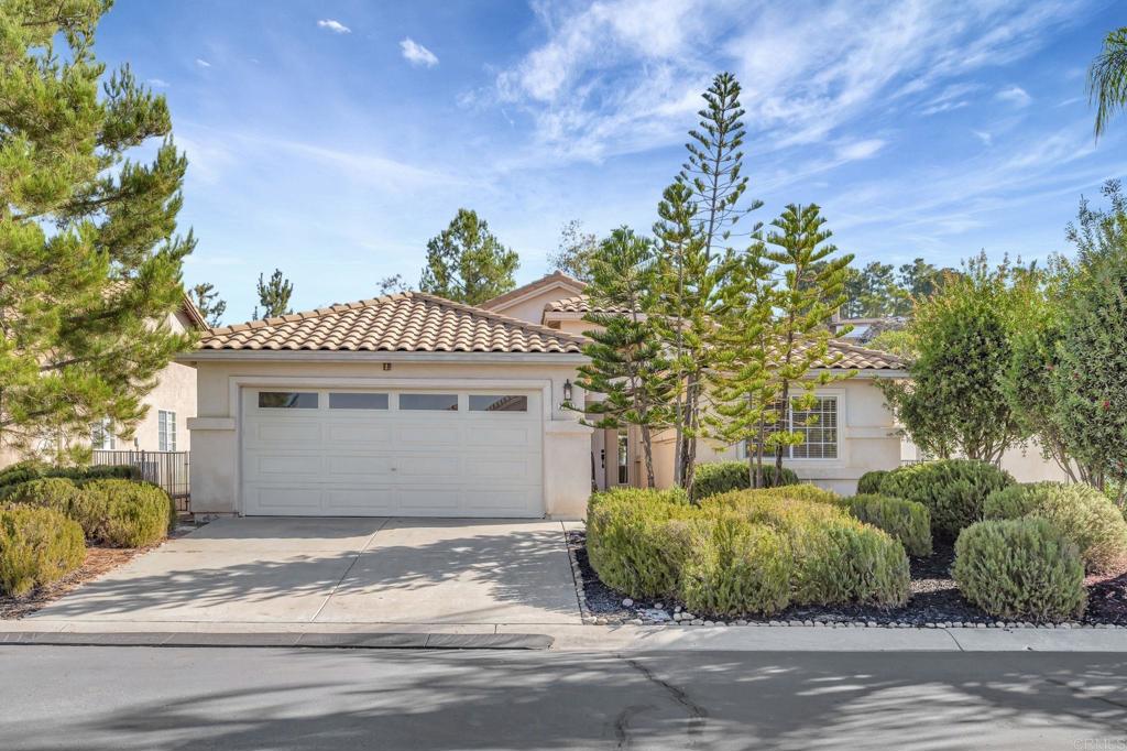 2775 Lobelia Road Alpine, CA 91901 - Photo 3 of 25 a front view of a house with a yard and garage