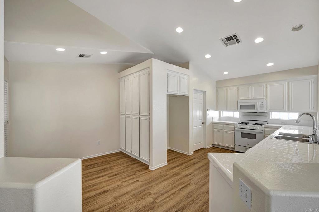 2775 Lobelia Road Alpine, CA 91901 - Photo 8 of 25 a kitchen with stainless steel appliances granite countertop a refrigerator a stove and a sink