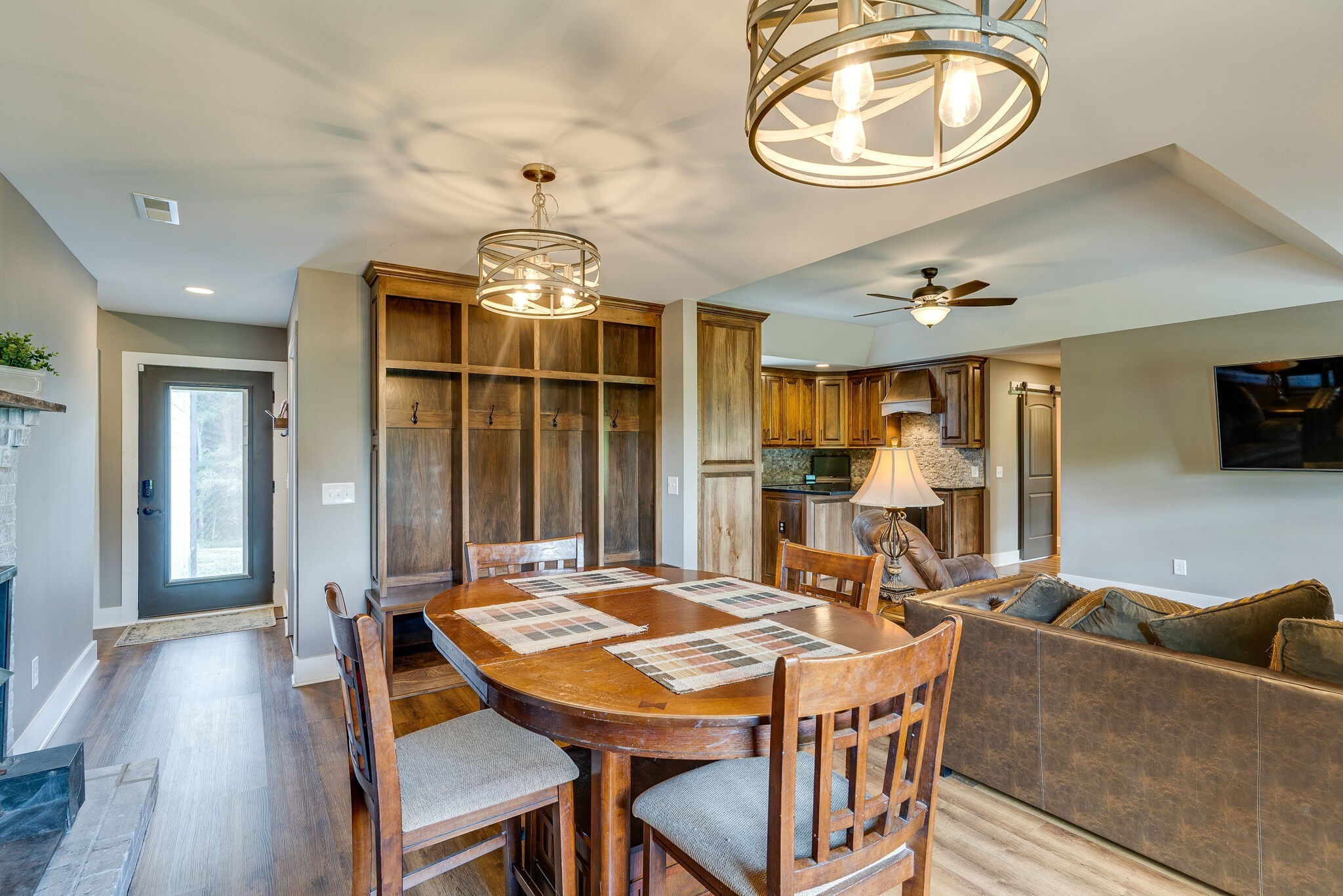 6626 Herbert Shannon Road Springfield, TN 37172 - Photo 8 of 19 a dining room with wooden floor a chandelier a wooden table and chairs