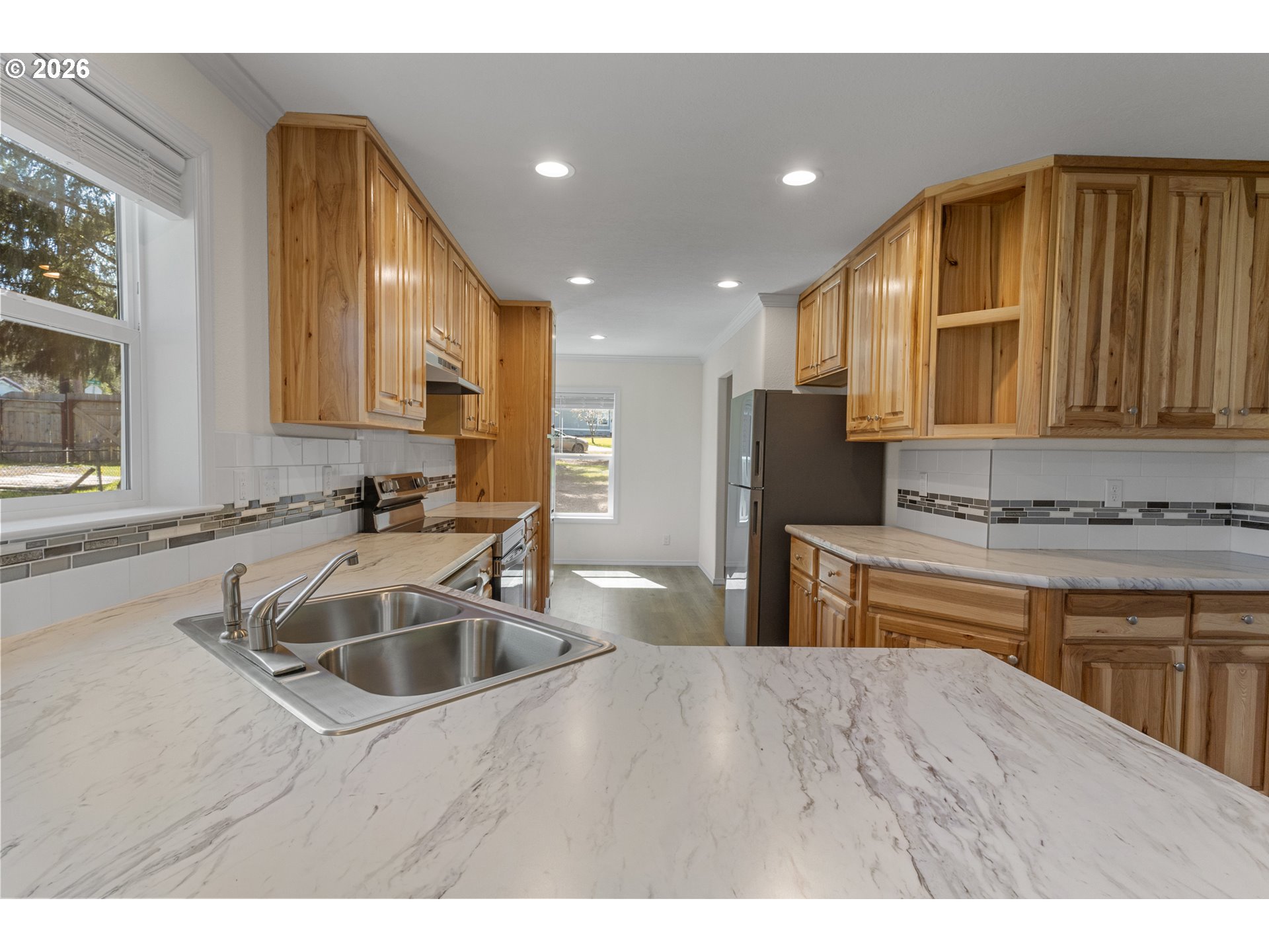 365 Mountain View Road Sweet Home, OR 97386 - Photo 12 of 32 a kitchen with kitchen island granite countertop a sink and refrigerator