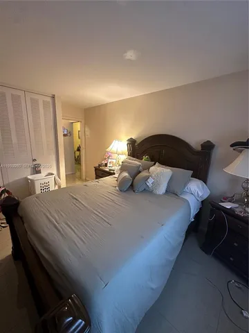 a bedroom with a bed and lamp