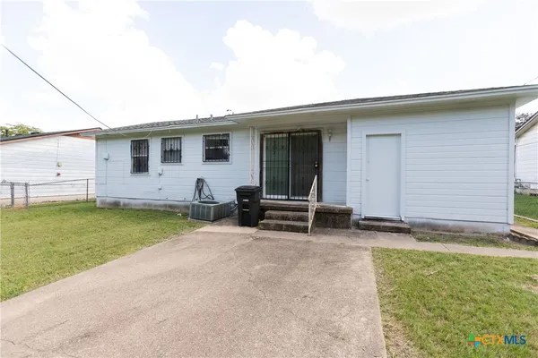 a view of a house with a backyard and a patio