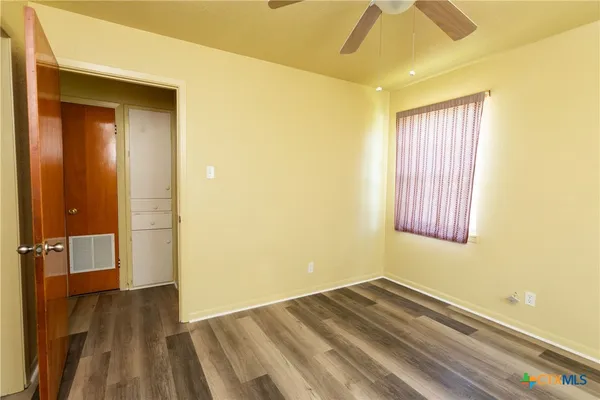 a view of a room with wooden floor and bathroom