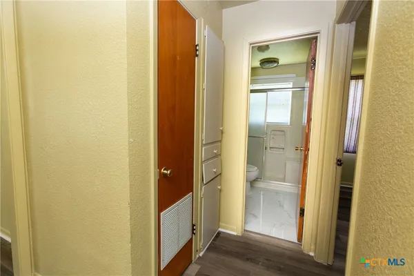 a view of a bathroom from a hallway