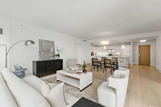 a living room with furniture and view of kitchen