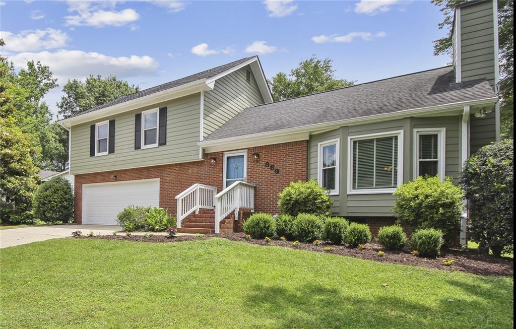 869 Cinderella Court Decatur, GA 30033 - Photo 1 of 1 a front view of a house with a garden and plants