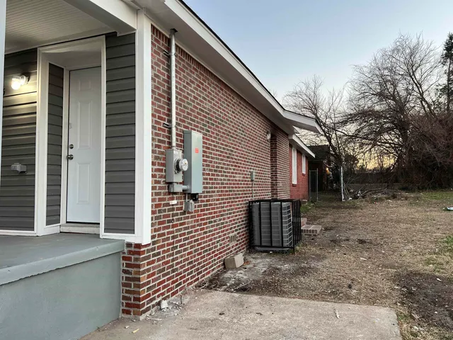 a view of a house with a yard and garage