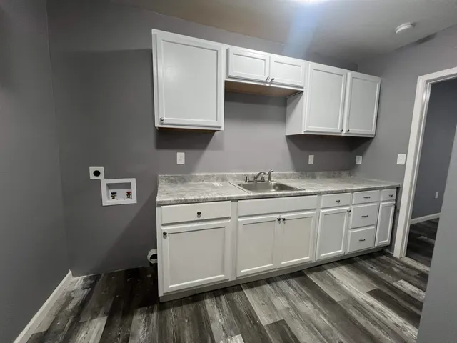 a kitchen with granite countertop cabinets stainless steel appliances and a sink